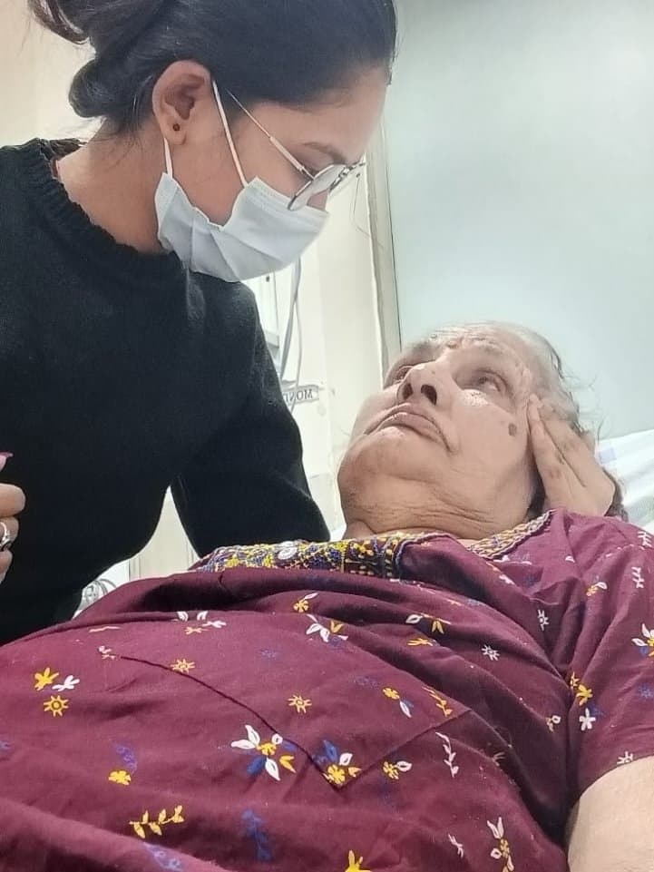 A caregiver checking on a patient